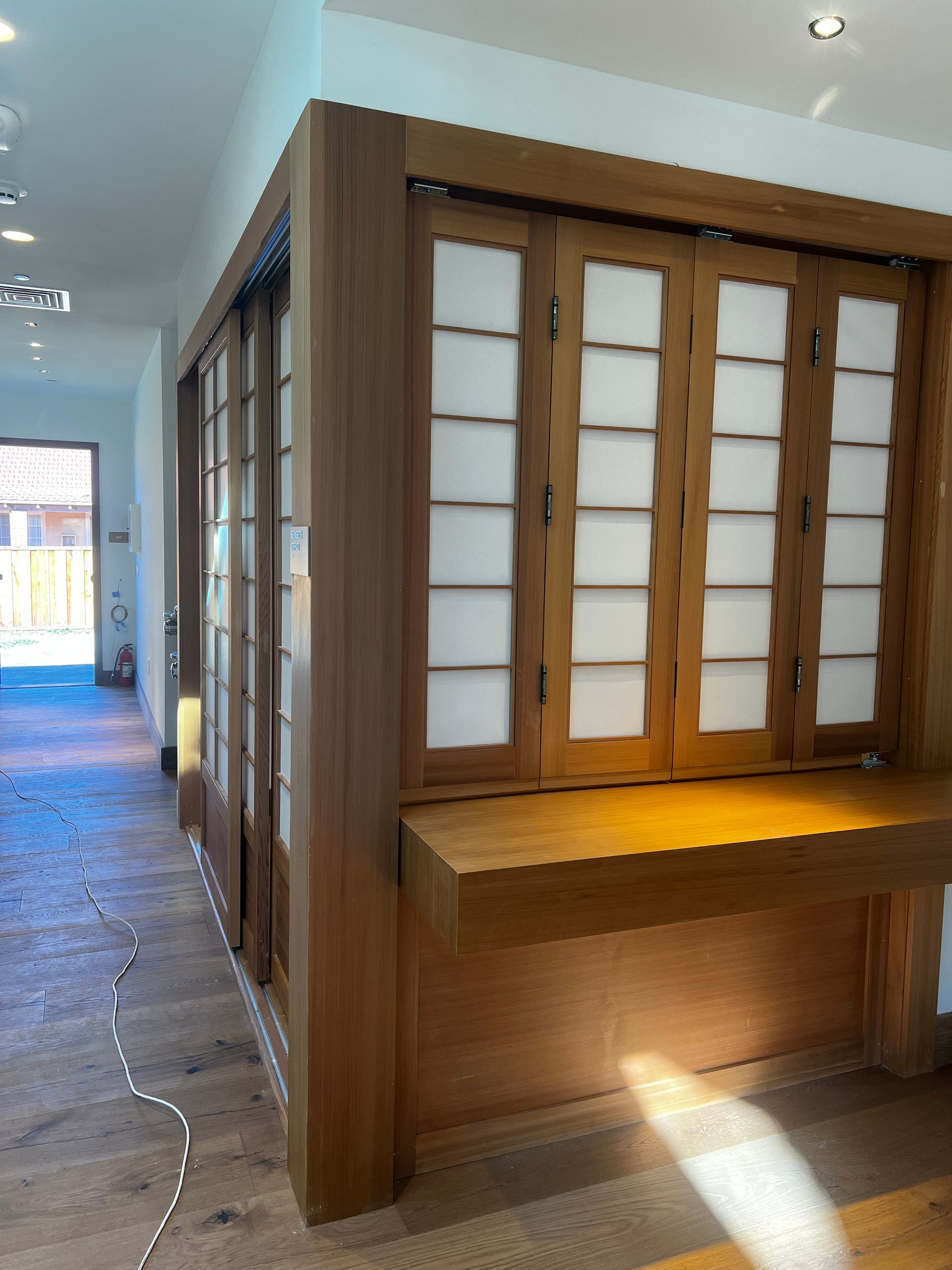 A hallway with wooden walls and sliding doors