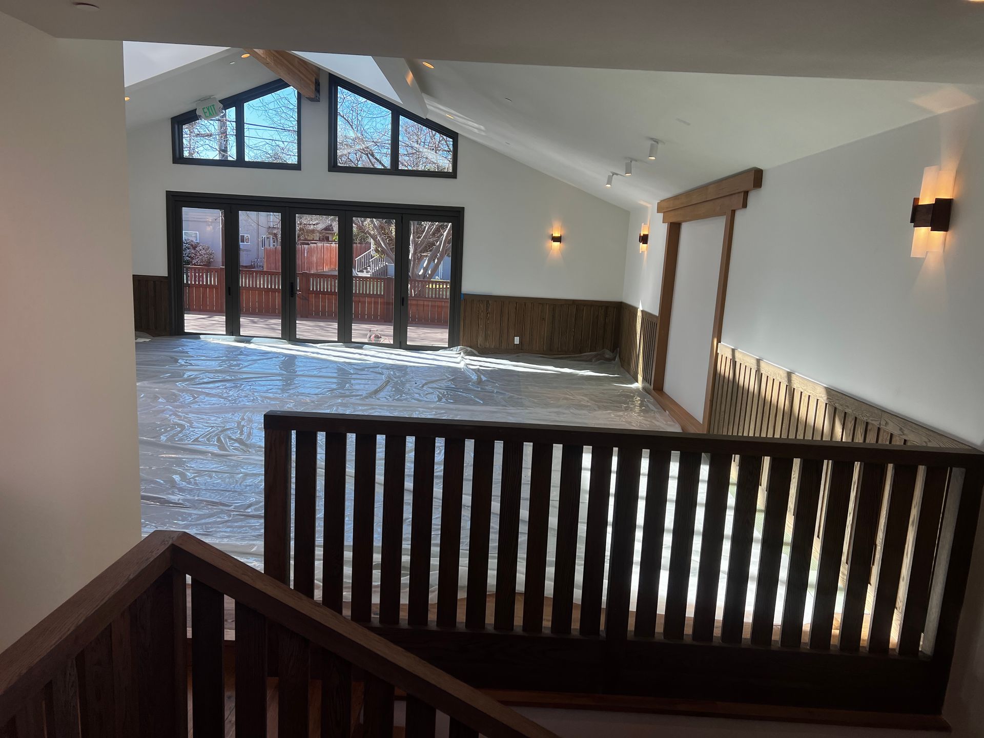 A staircase leading up to a large room with a wooden railing