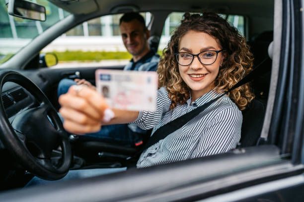 Happy student passes manual driving test with instructor's support.