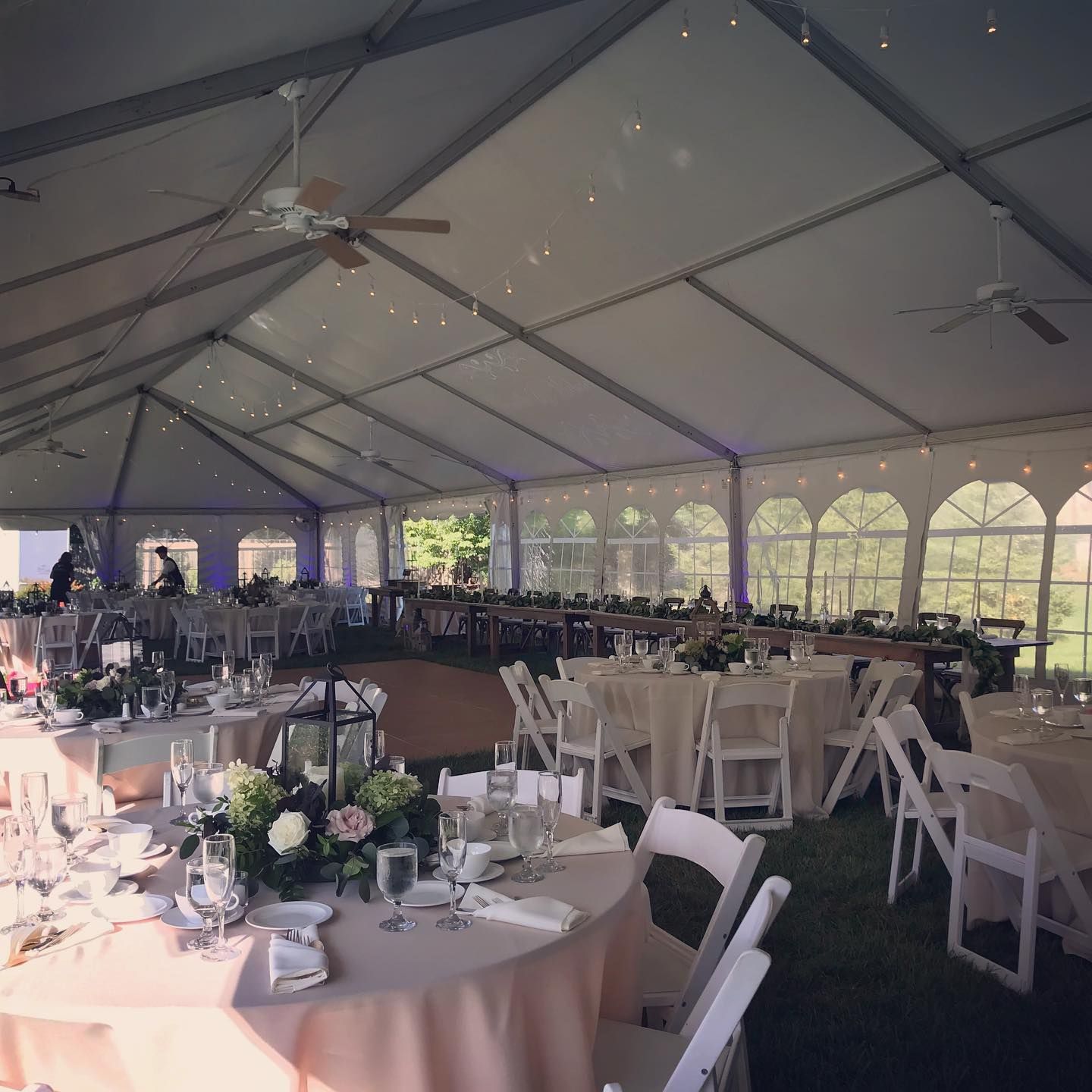 Person receiving a pedicure. Technician wearing gloves, working on foot near a bowl and nail polish.