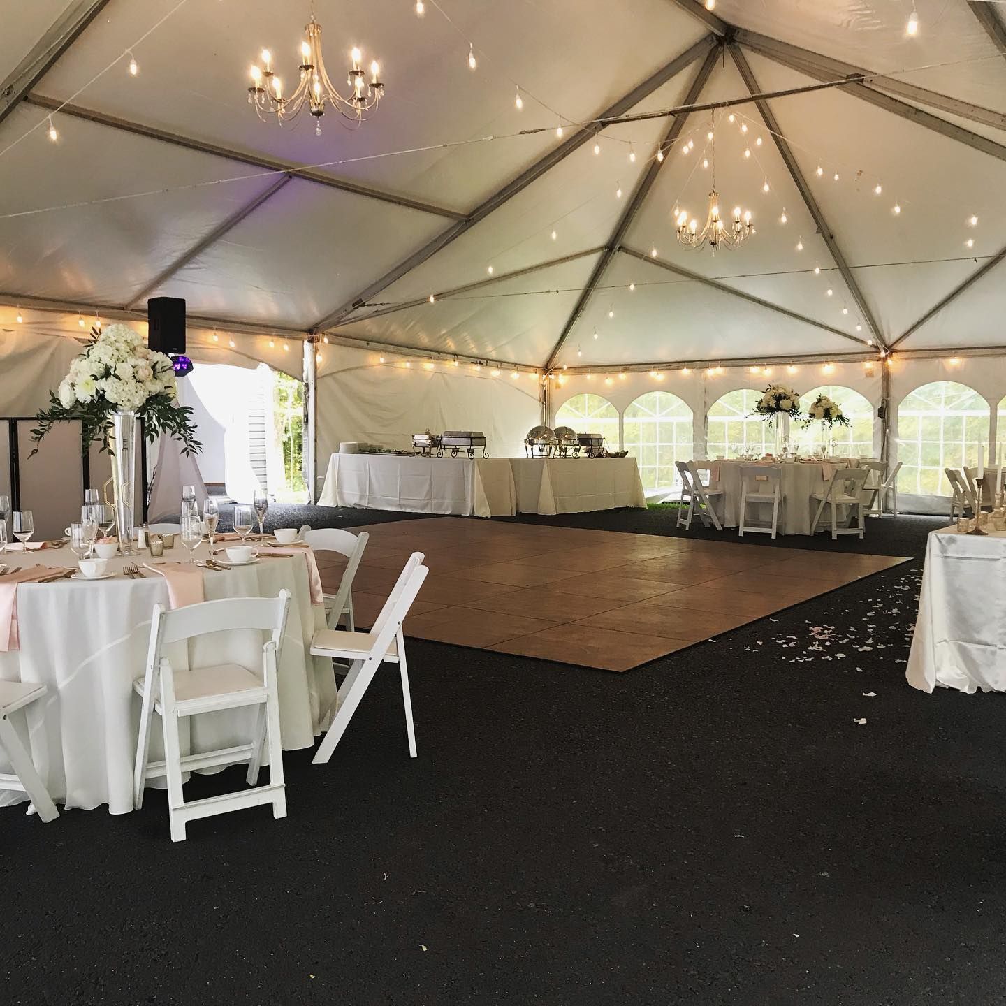 Person receiving a pedicure. Technician wearing gloves, working on foot near a bowl and nail polish.