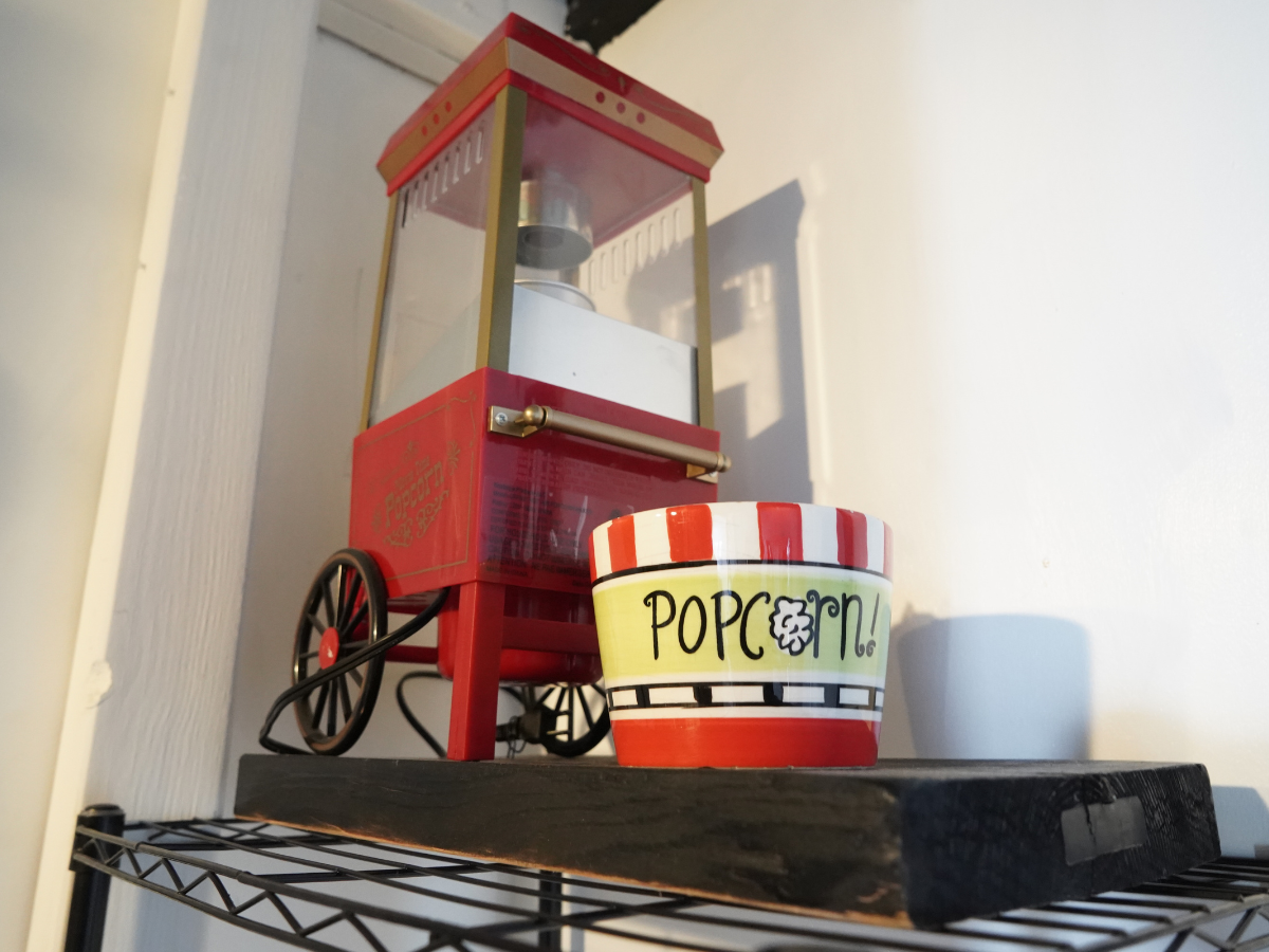 Person receiving a pedicure. Technician wearing gloves, working on foot near a bowl and nail polish.