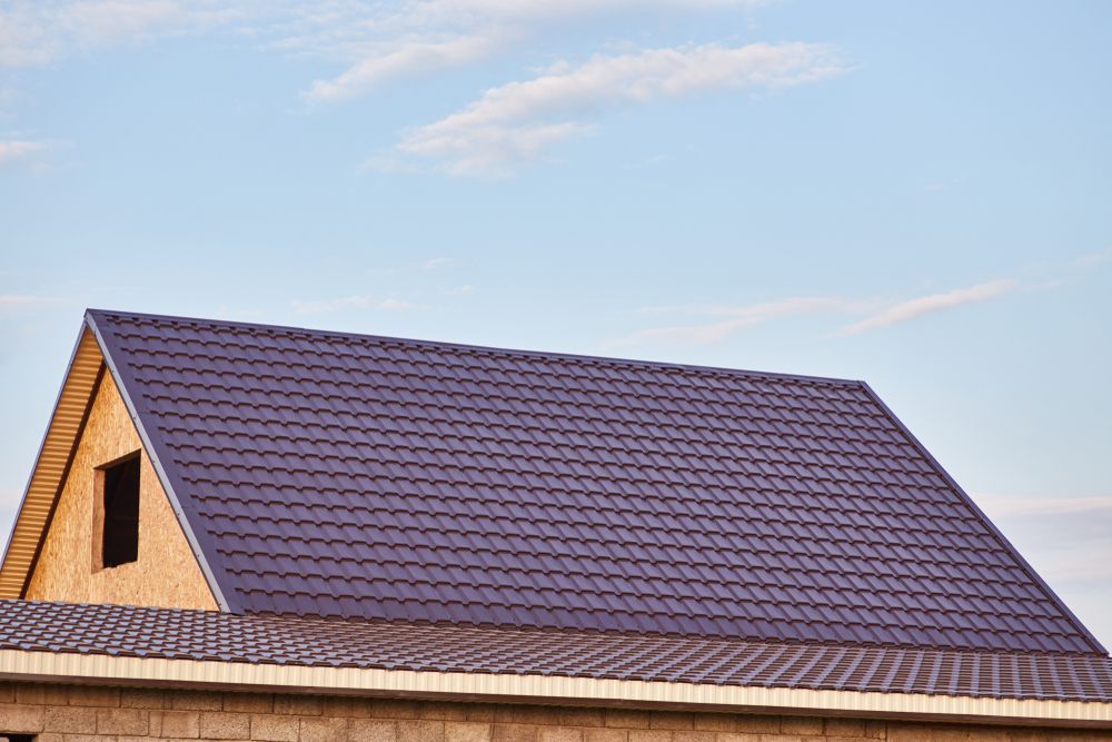 A House Under Construction With a Purple Roof and a Window — Leonard Gray Roof Tiling In Casino, NSW