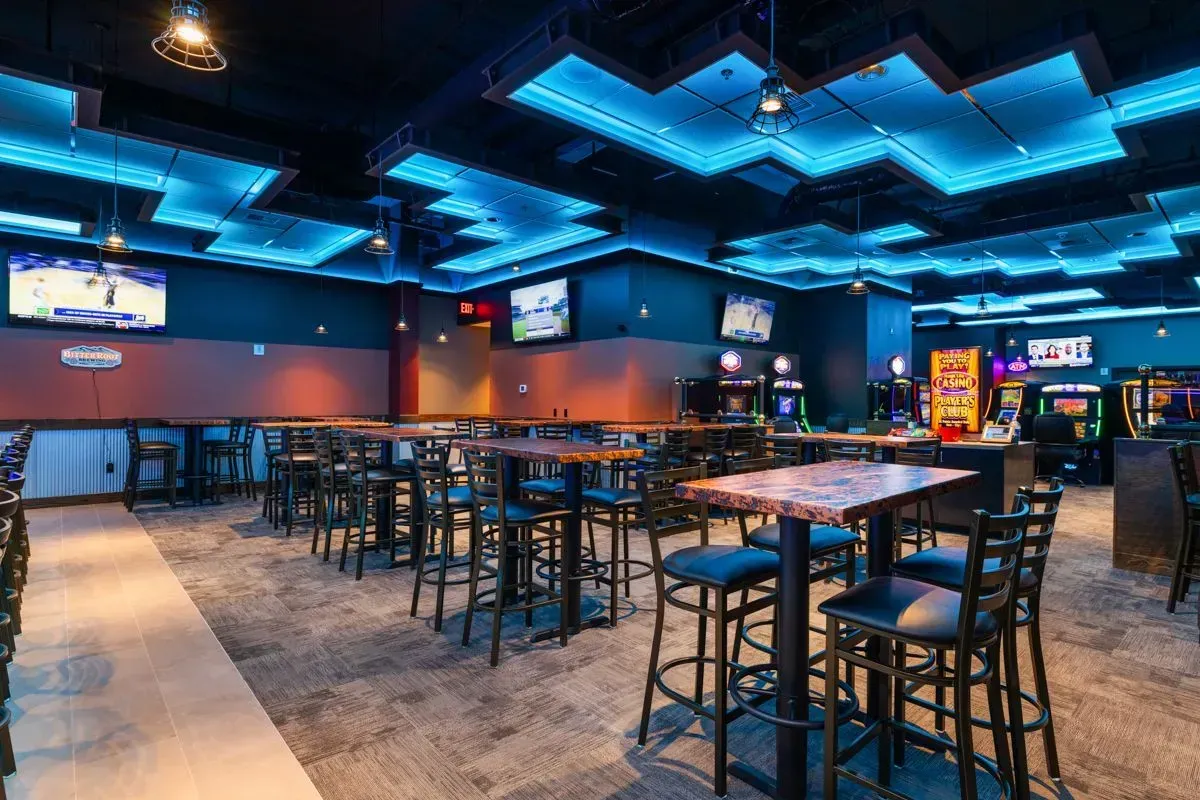 There are a lot of tables and chairs in this room.