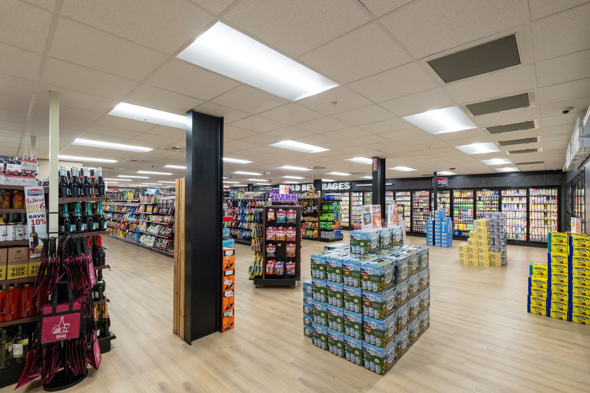 A large grocery store with lots of shelves and boxes on the floor.
