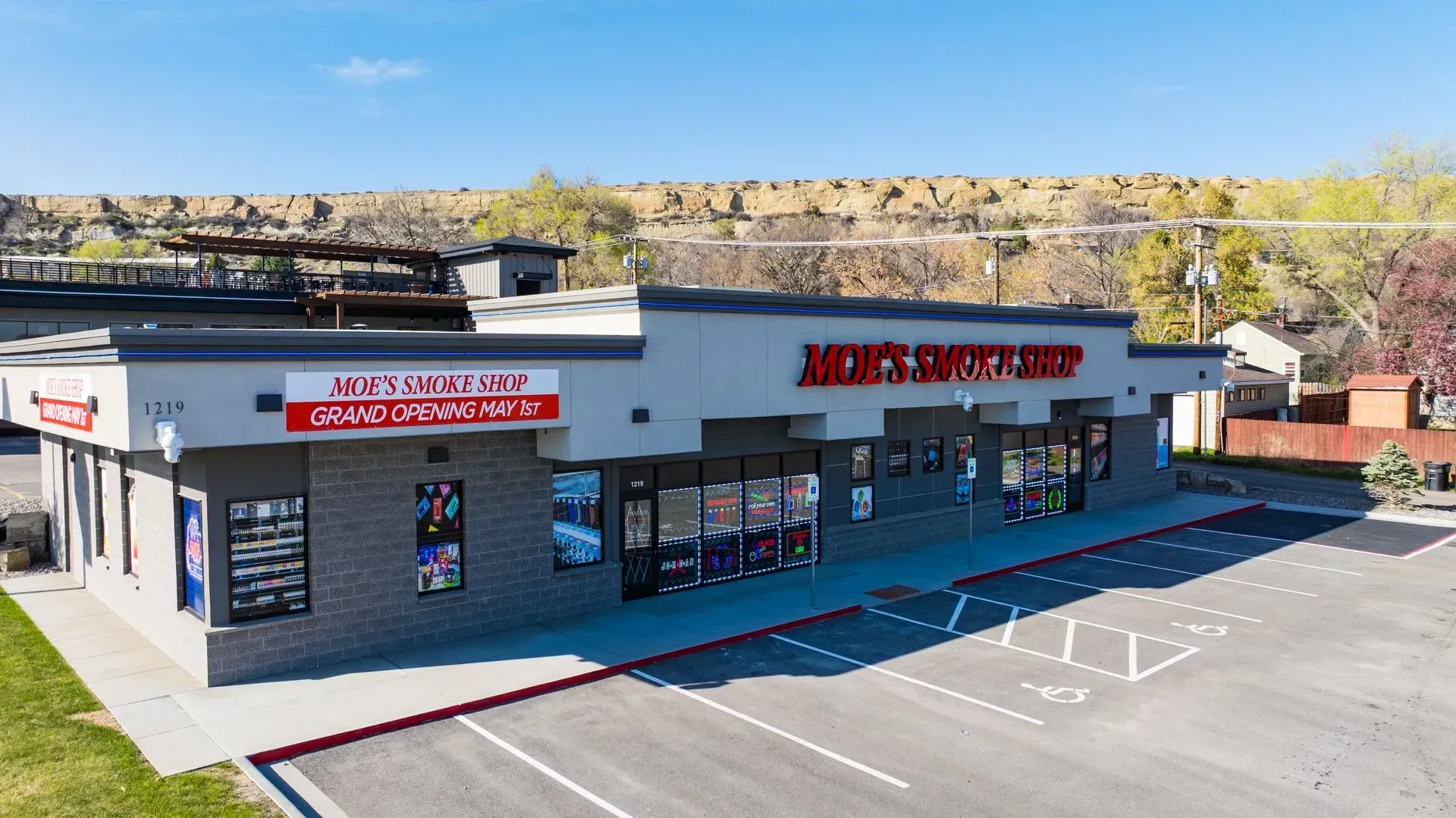 An aerial view of a store with a parking lot in front of it.