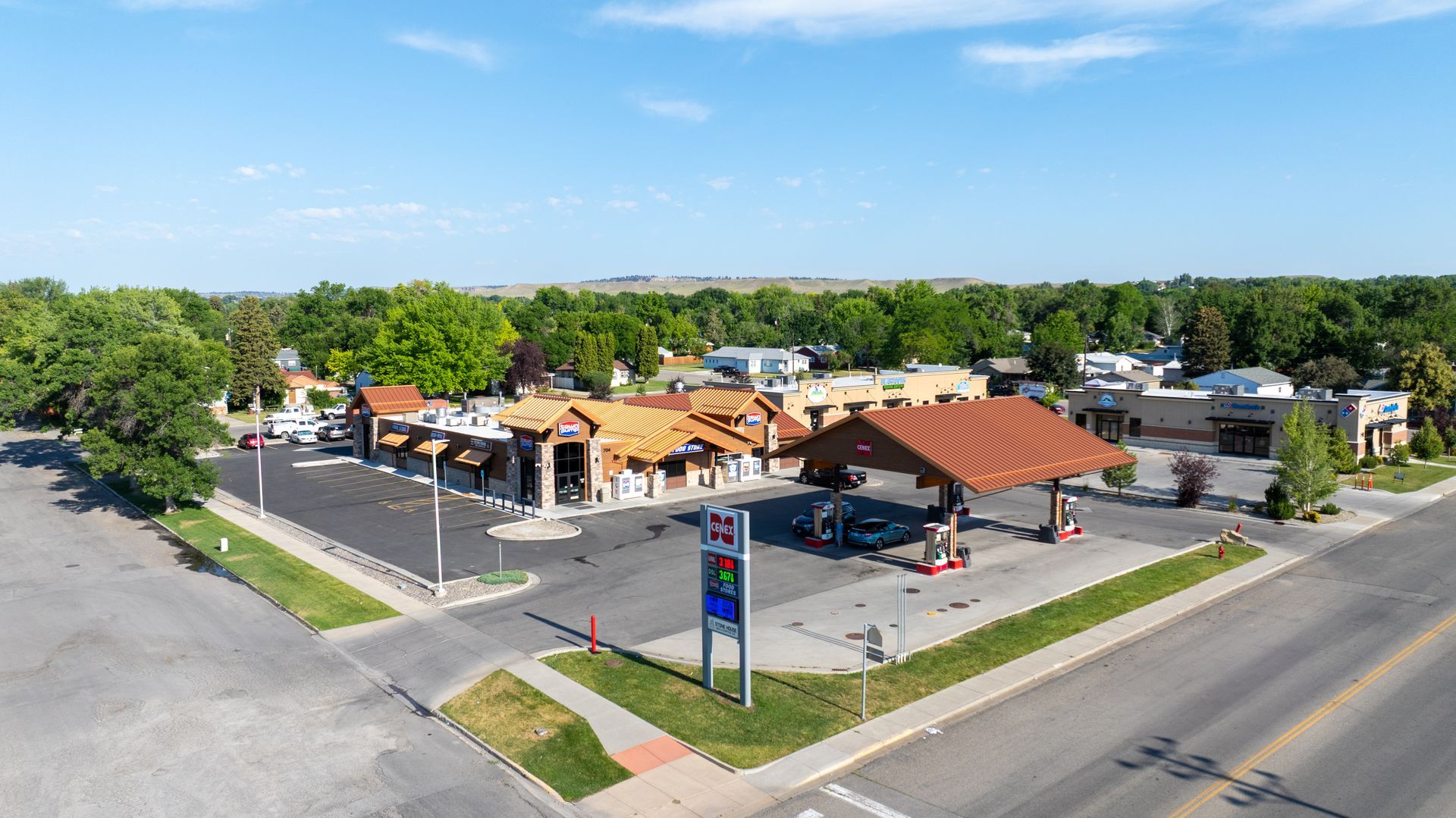 An aerial view of a gas station in a small town.