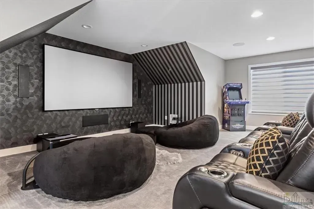 A home theater with a projector screen and bean bag chairs.