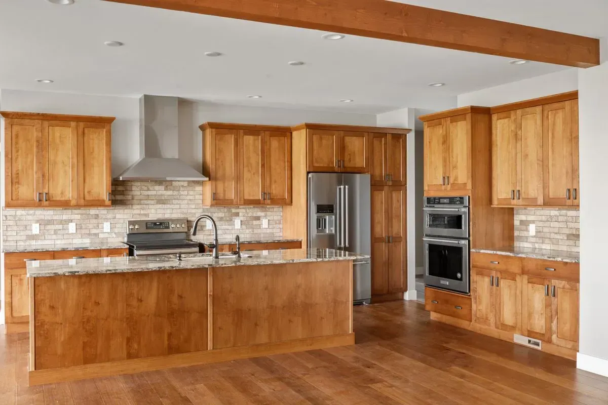 A kitchen with wooden cabinets and stainless steel appliances.