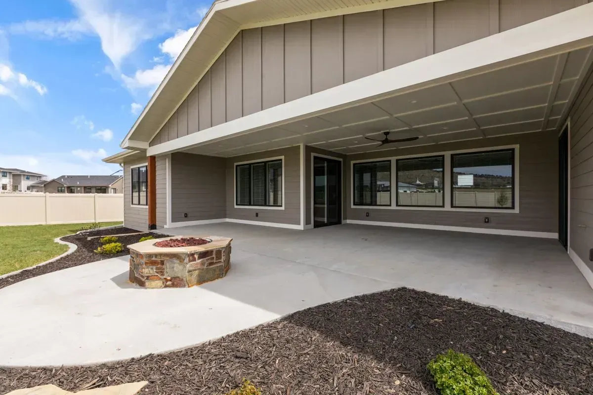 There is a fire pit in the backyard of a house.