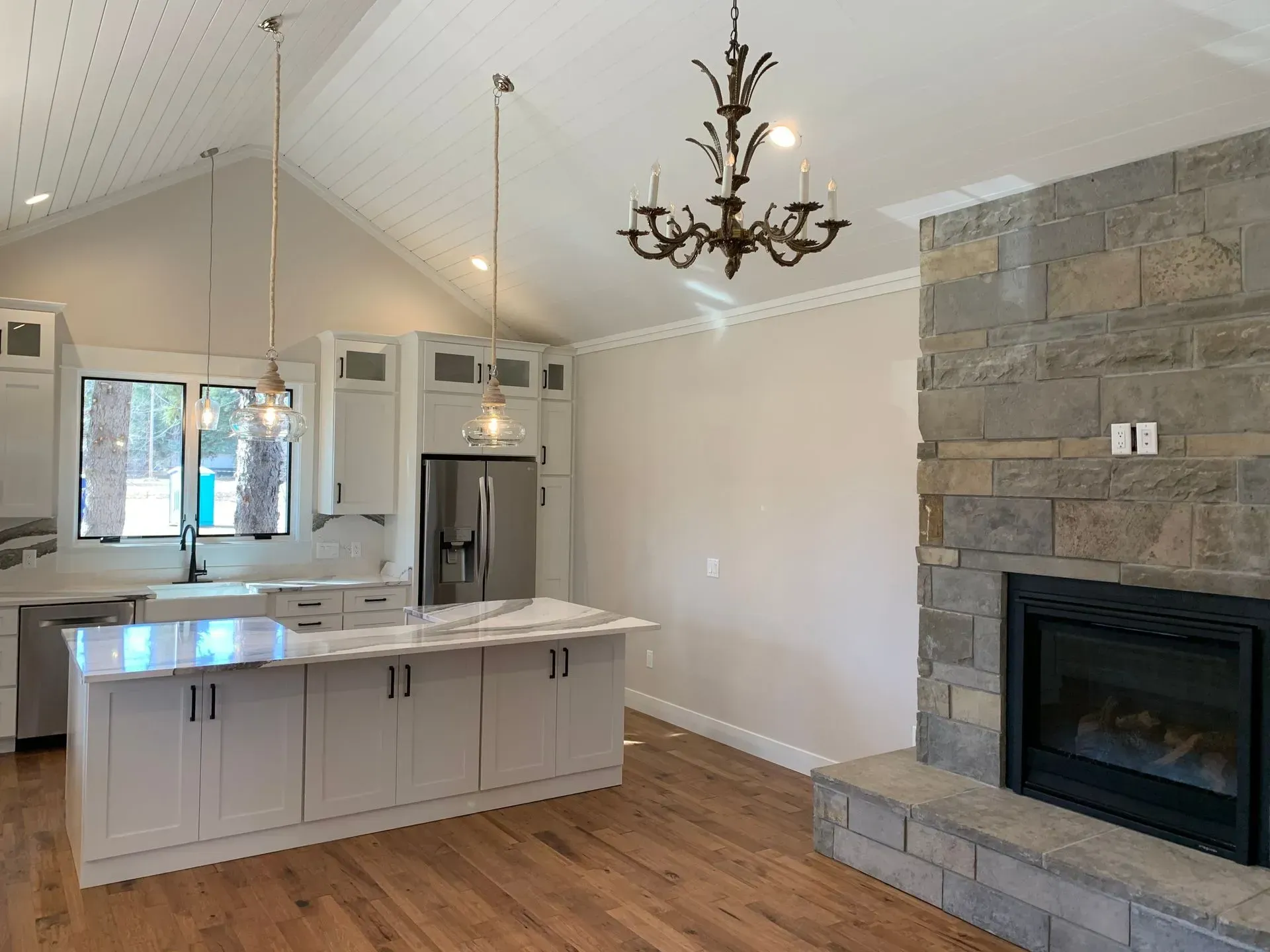 There is a fireplace in the middle of the kitchen.