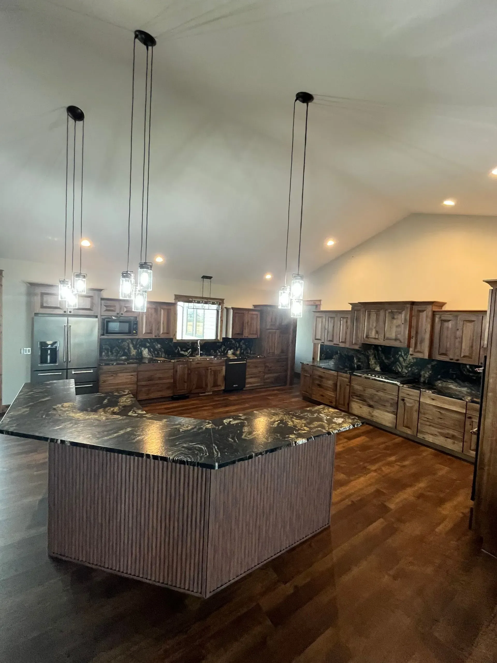 A large kitchen with a large island in the middle