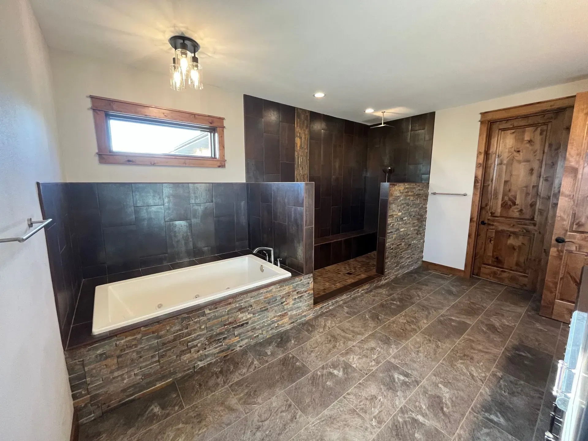 A bathroom with a tub and a walk in shower.