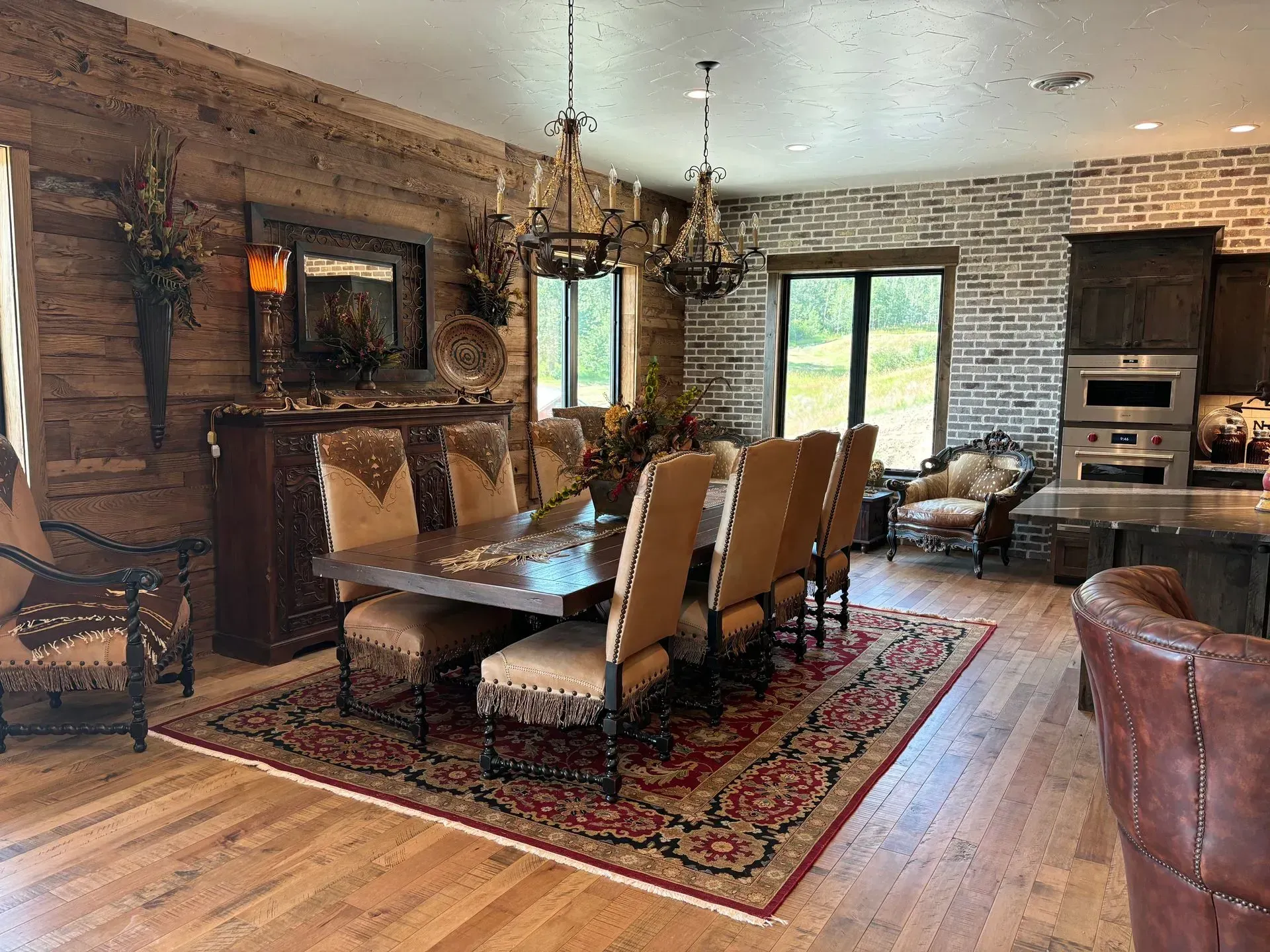 A dining room with a table and chairs and a rug.