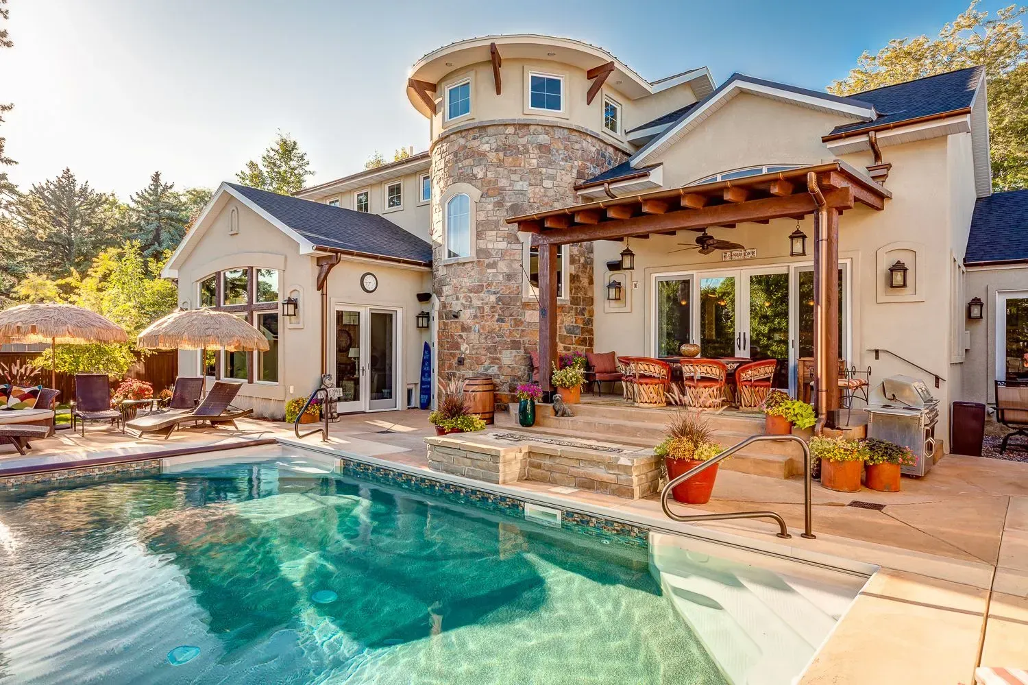 A large house with a swimming pool in front of it.