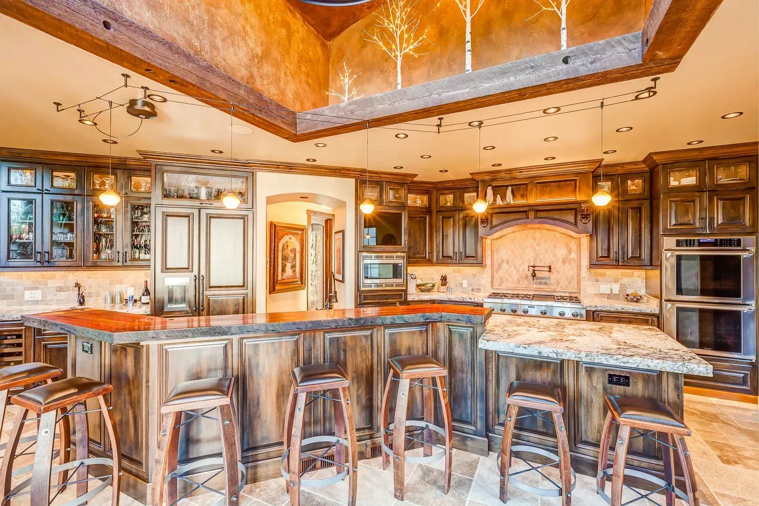 A large kitchen with a large island and stools.