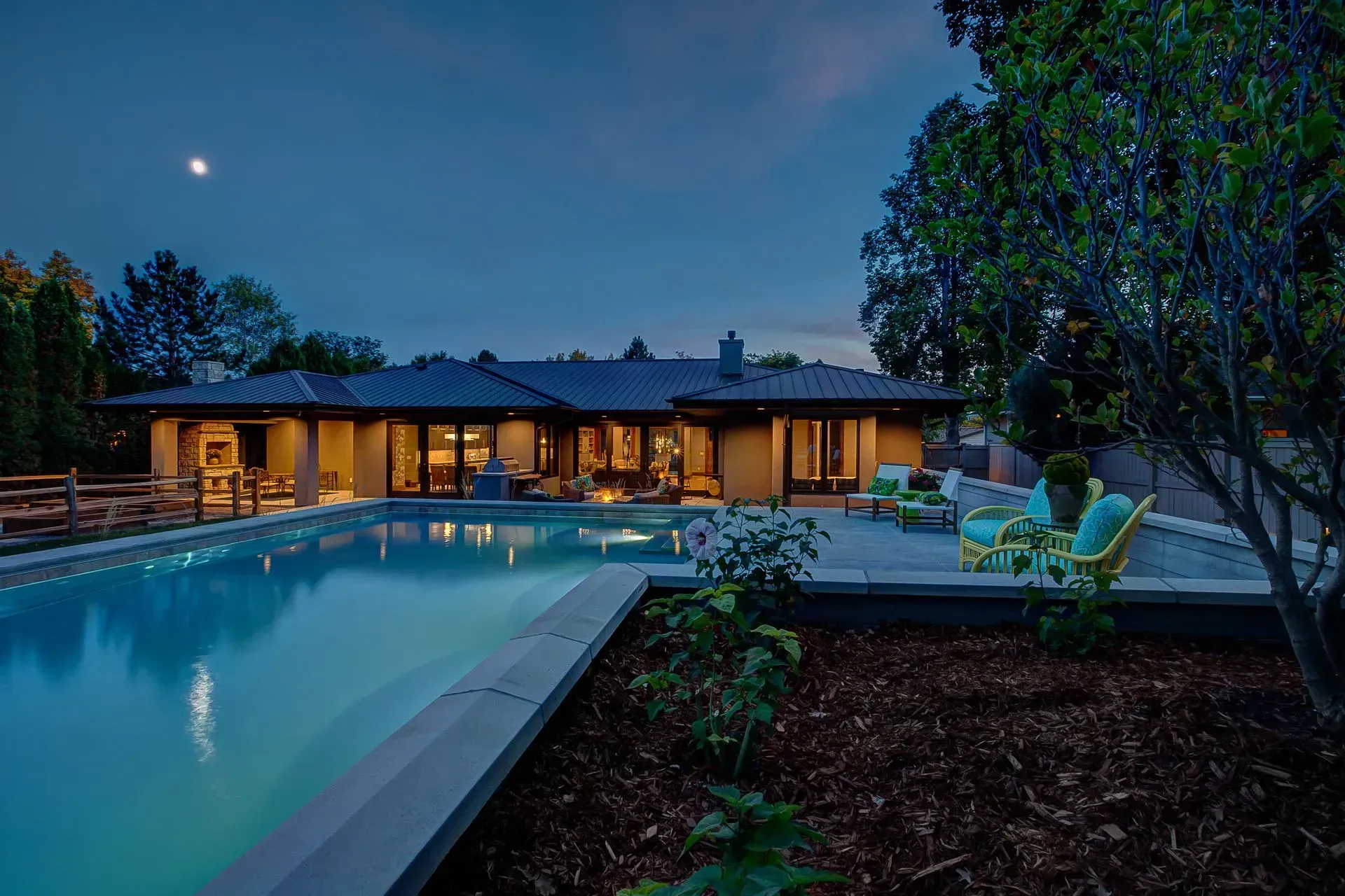 A large house with a large swimming pool in front of it