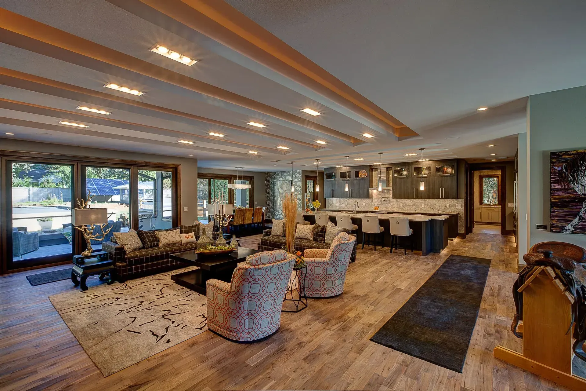 A living room filled with furniture and a kitchen in a house.