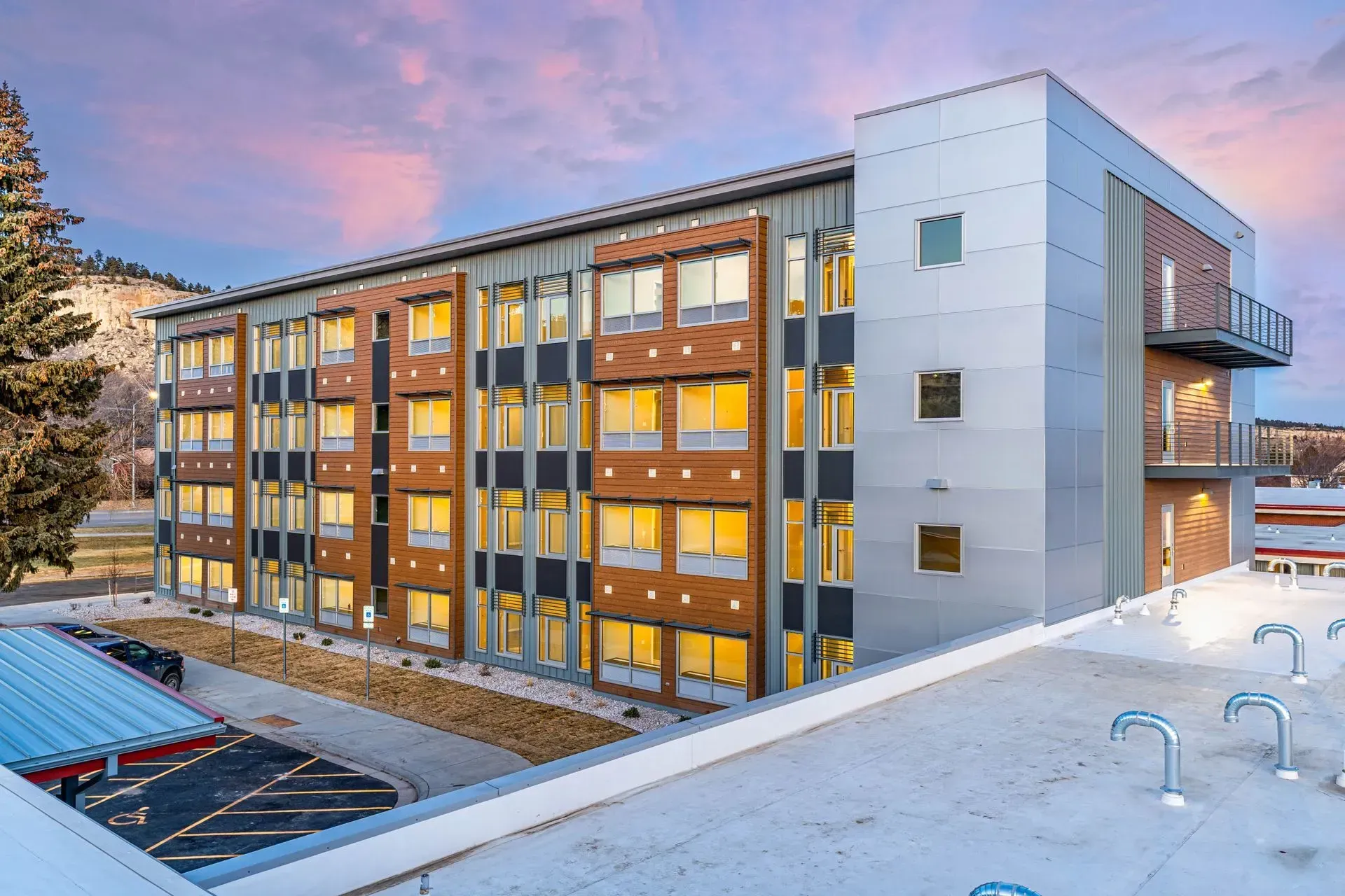 A large building with a lot of windows is lit up at night.