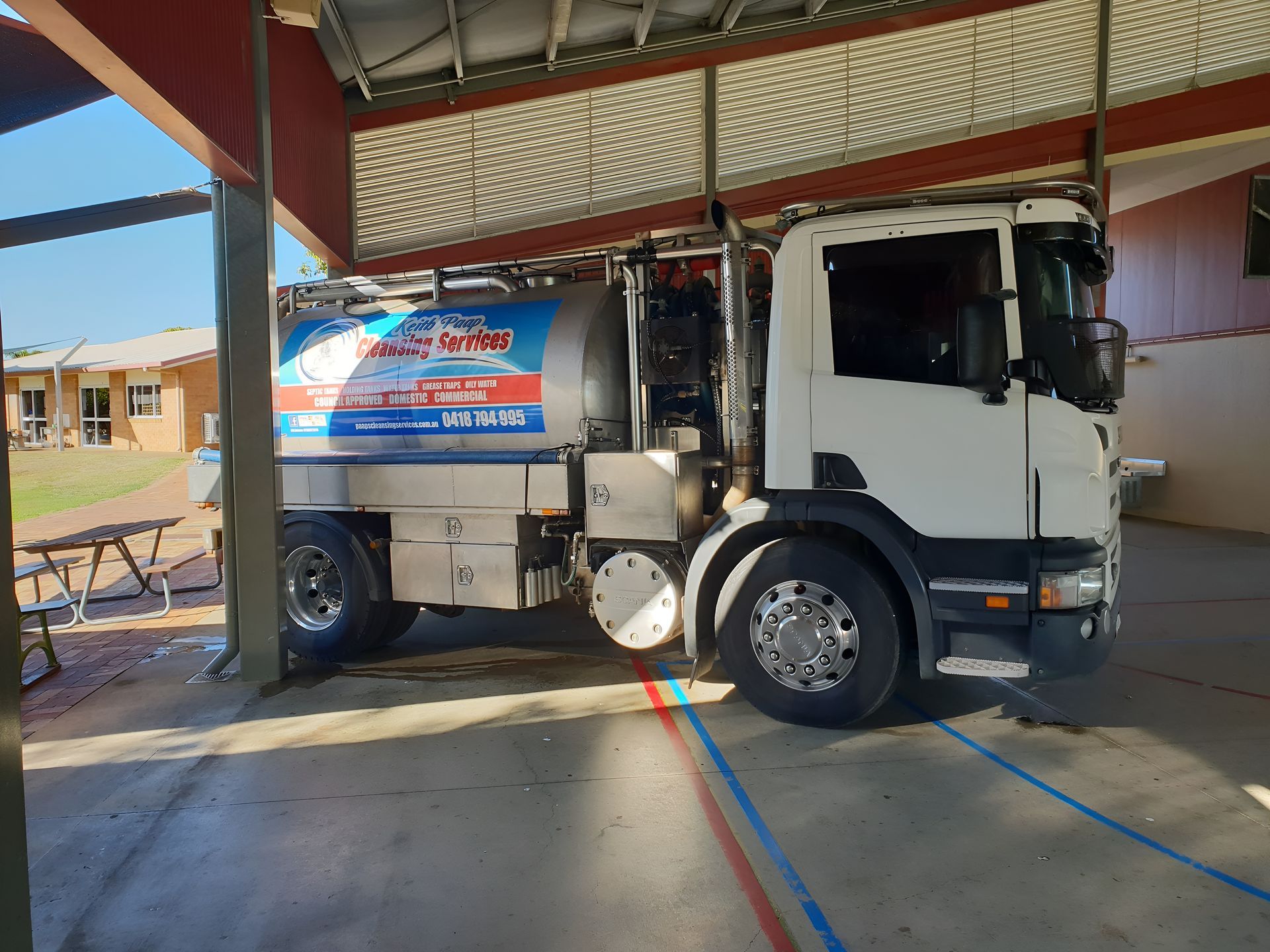 White Tanker Truck Under a Shelter — Paap's Cleansing Services in Branyan, QLD