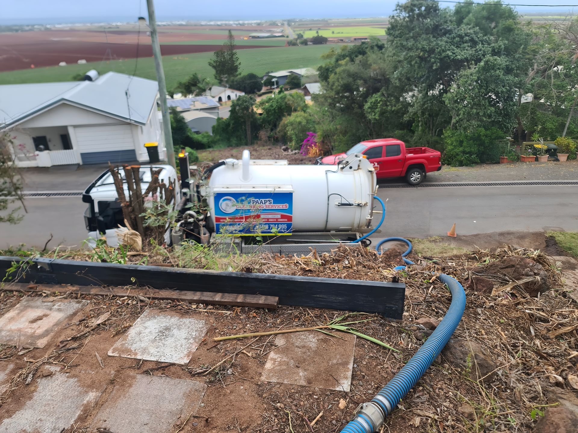 Truck With a White Tank Pumping Waste Uphill — Paap's Cleansing Services in Branyan, QLD