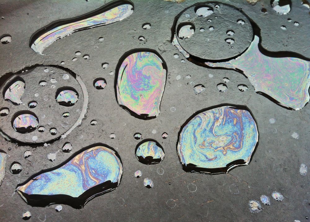 Colorful Oil Slick on a Dark Surface, Displaying Iridescent Patterns — Paap's Cleansing Services in Branyan, QLD
