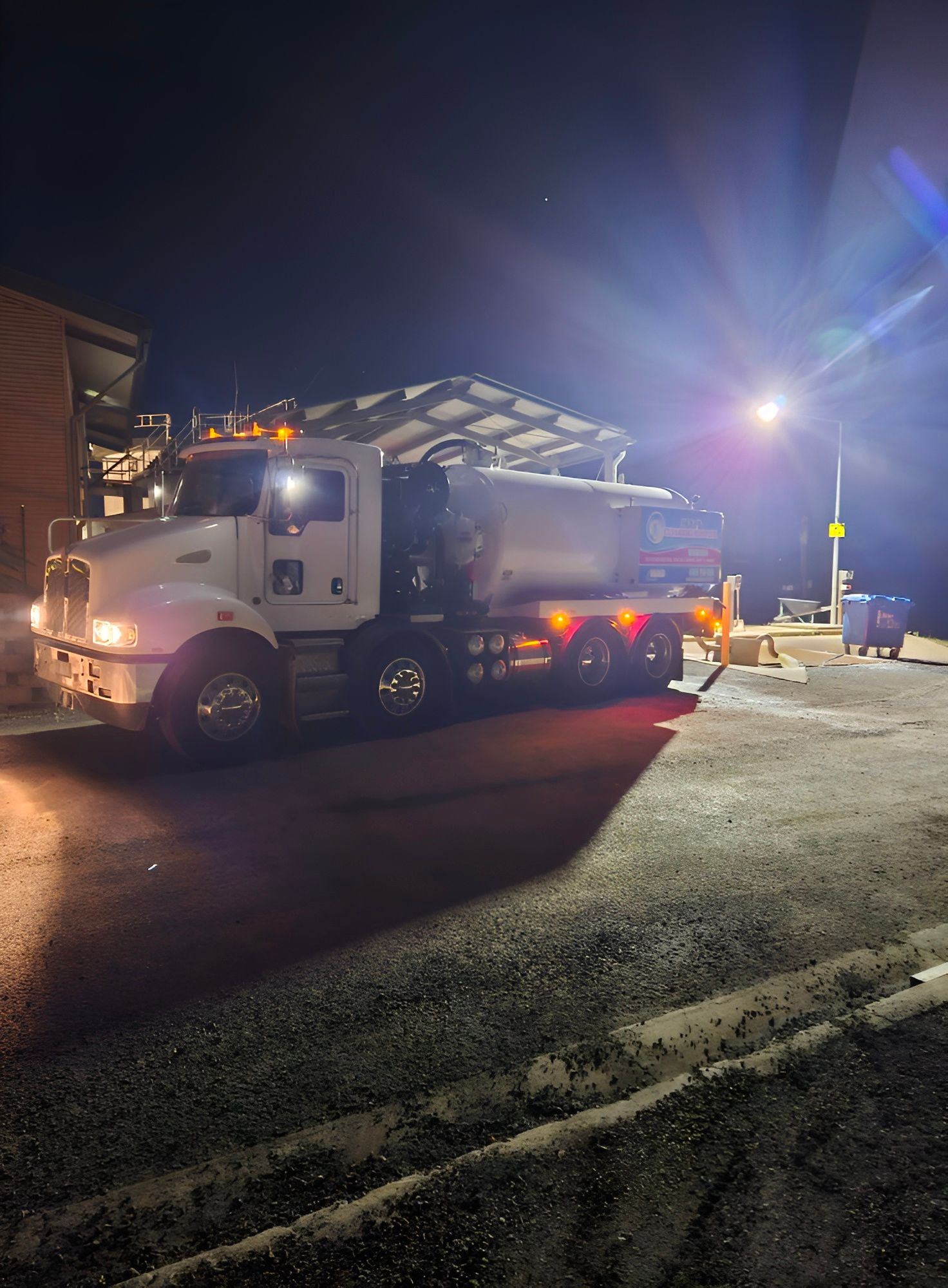 White Tanker Truck Parked at Night — Paap's Cleansing Services in Woodgate, QLD