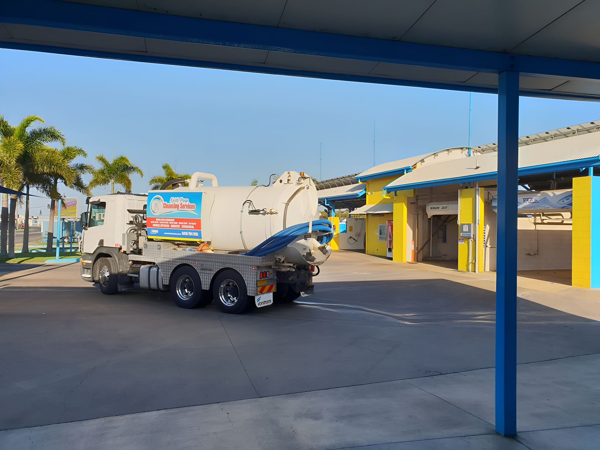 White Truck With Vacuum Tank Parked Outside a Building — Paap's Cleansing Services in Gin Gin, QLD