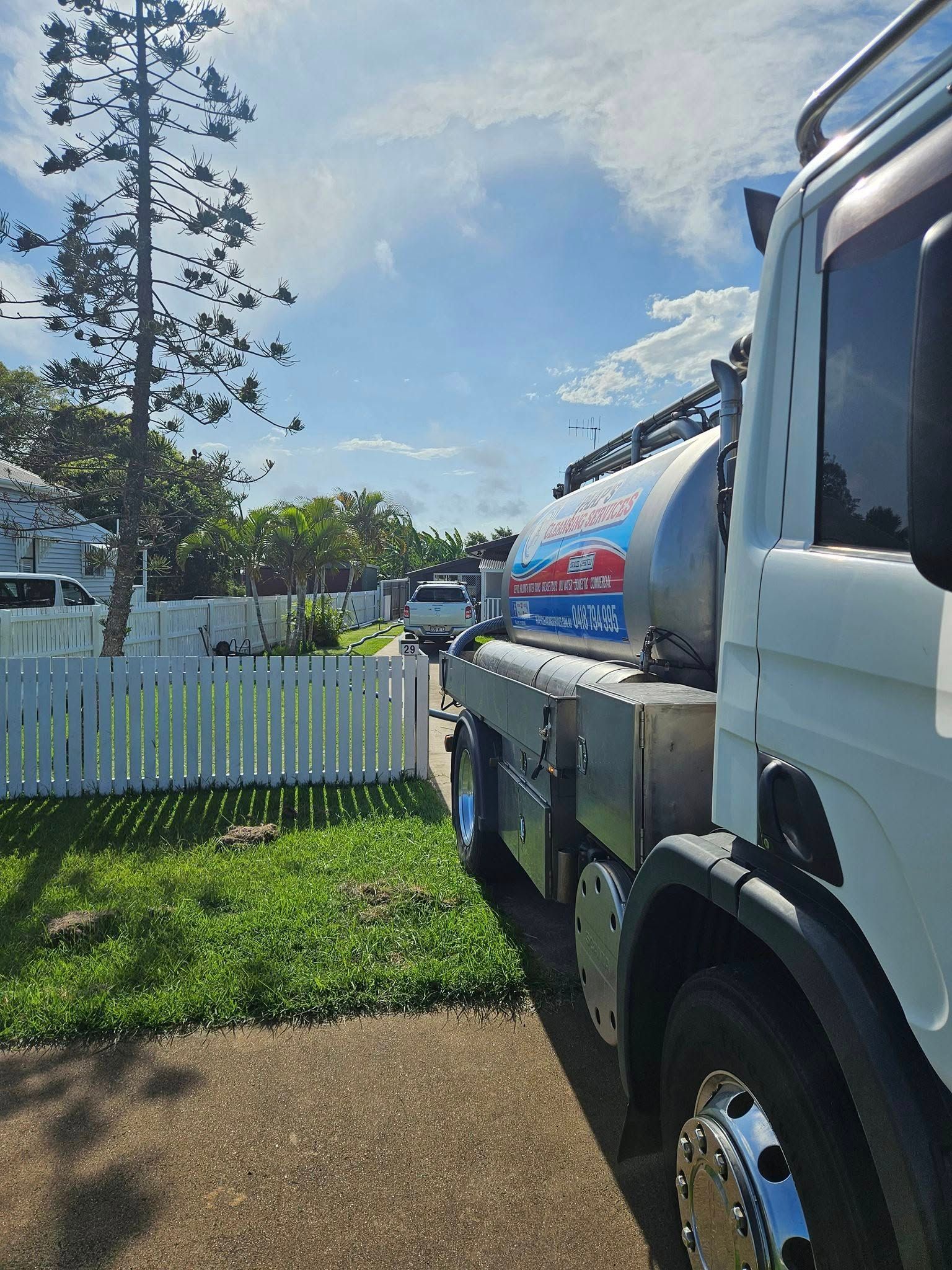 White Tanker Truck Parked on the Street — Paap's Cleansing Services in Burrum Heads, QLD