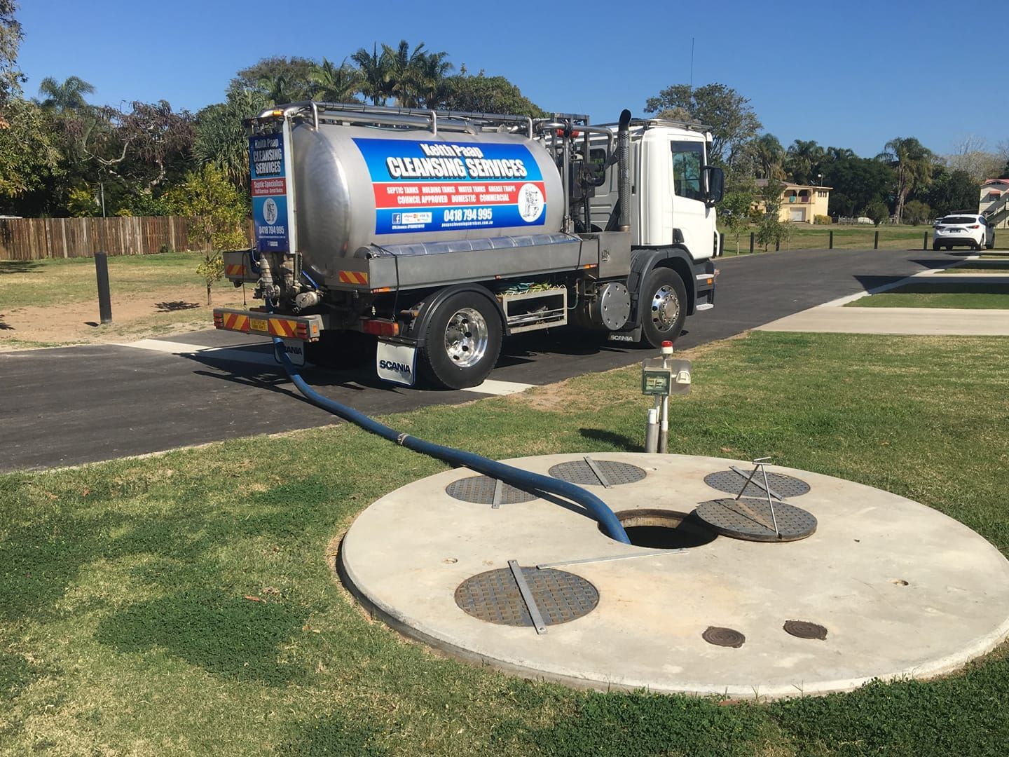 A Septic Tank Pumping Truck Parked Near an Open Septic Tank — Paap's Cleansing Services in Mount Perry, QLD