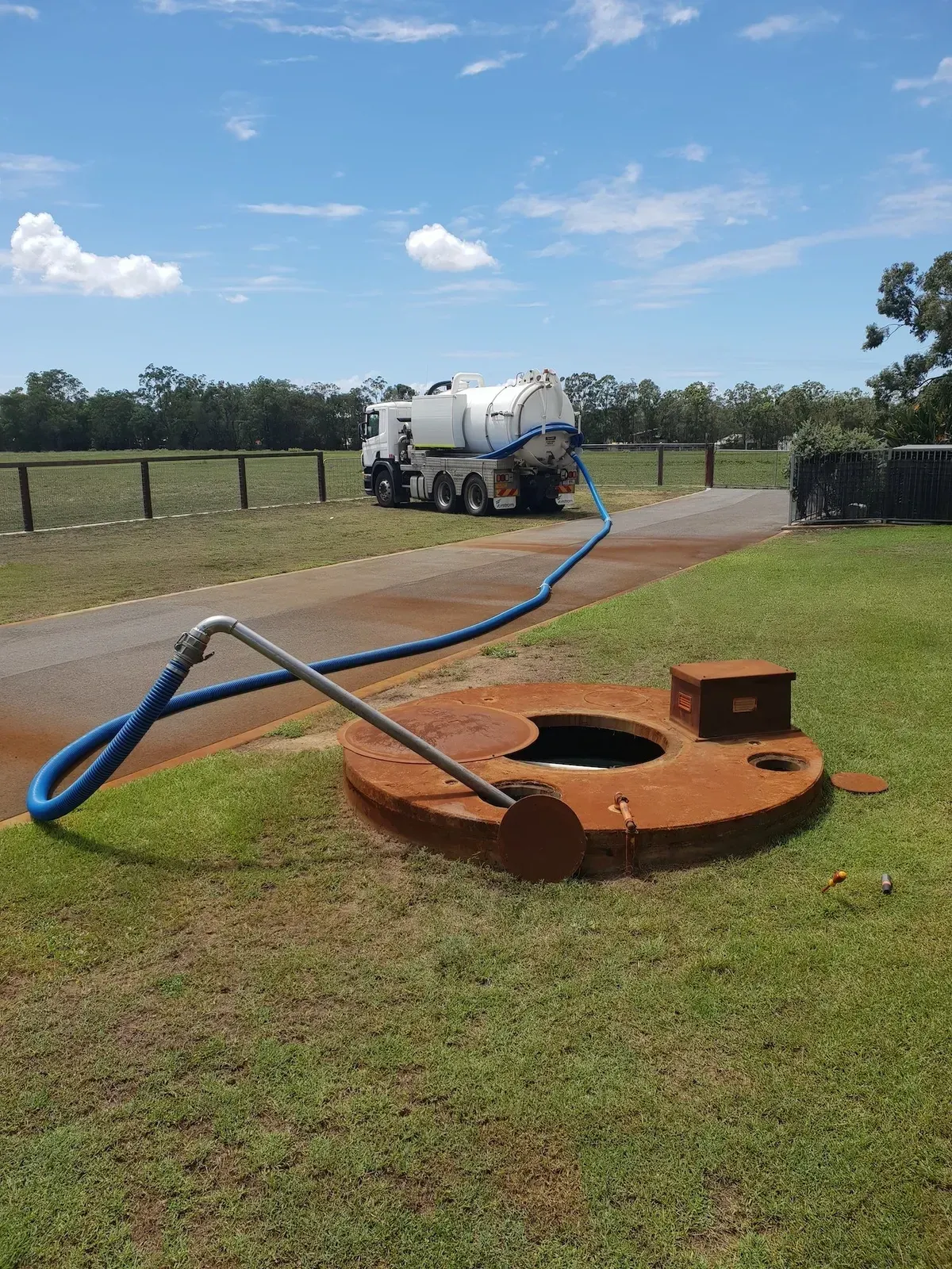 Septic Tank Being Serviced by a White Vacuum Truck — Paap's Cleansing Services in Branyan, QLD