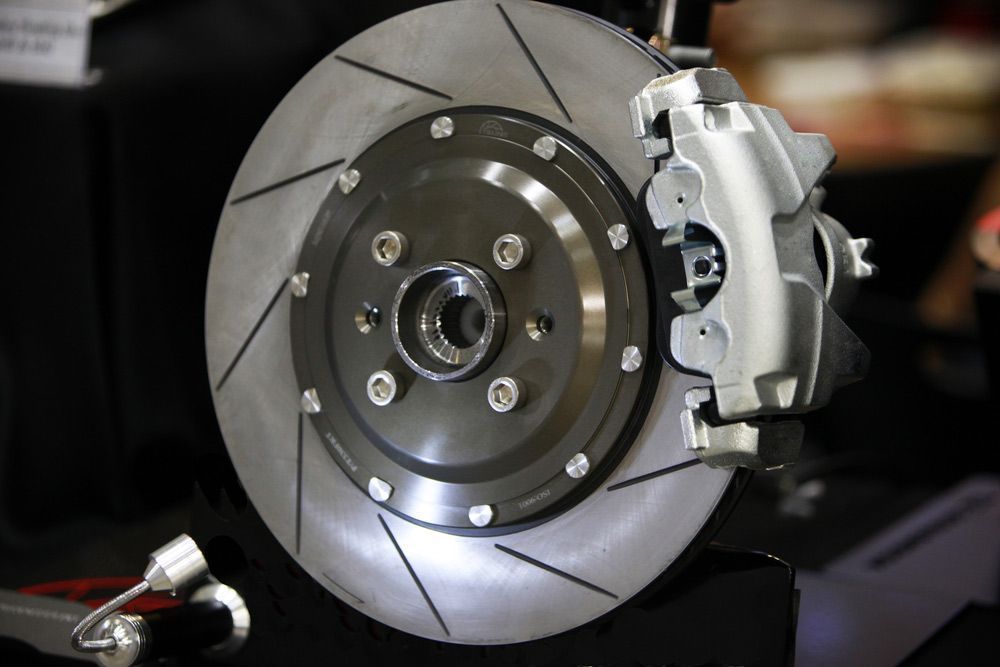 An Automobile Disc Brake Assembly with Slotted Rotor and Silver Caliper — Hervey Bay Brake and Exhaust in Pialba, QLD