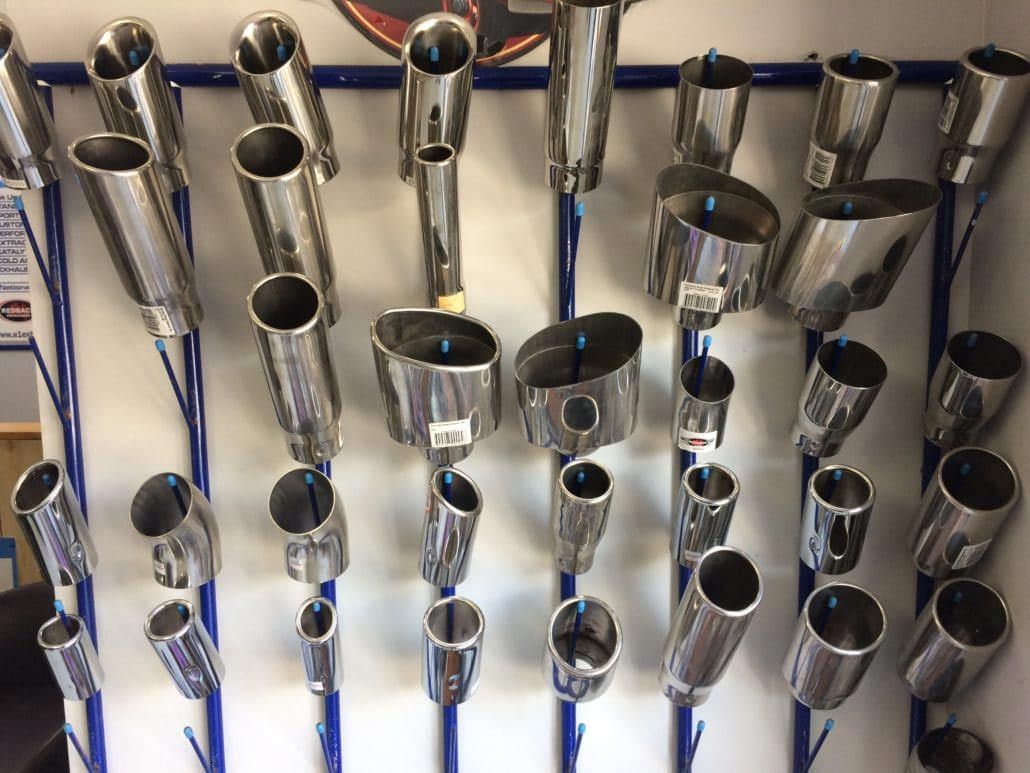 A Display of Various Chrome Exhaust Tips on A Rack — Hervey Bay Brake and Exhaust in Pialba, QLD