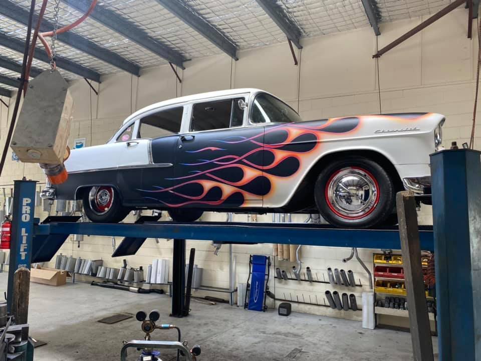 A Classic Car with Flames on A Lift in A Garage — Hervey Bay Brake and Exhaust in Pialba, QLD