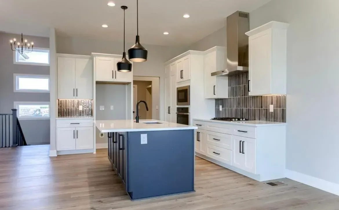 There is a large island in the middle of the kitchen.