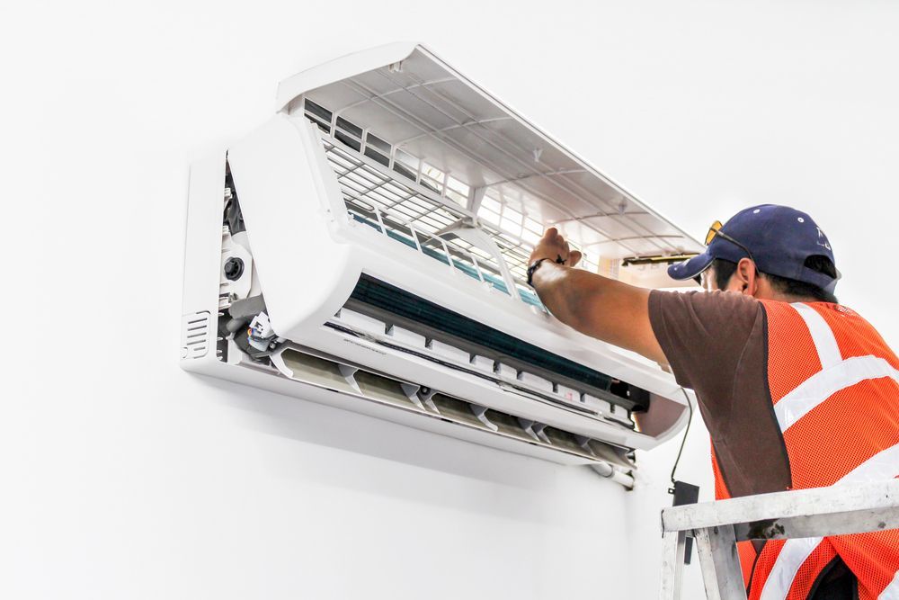 air conditioning technician working on a mini split unit