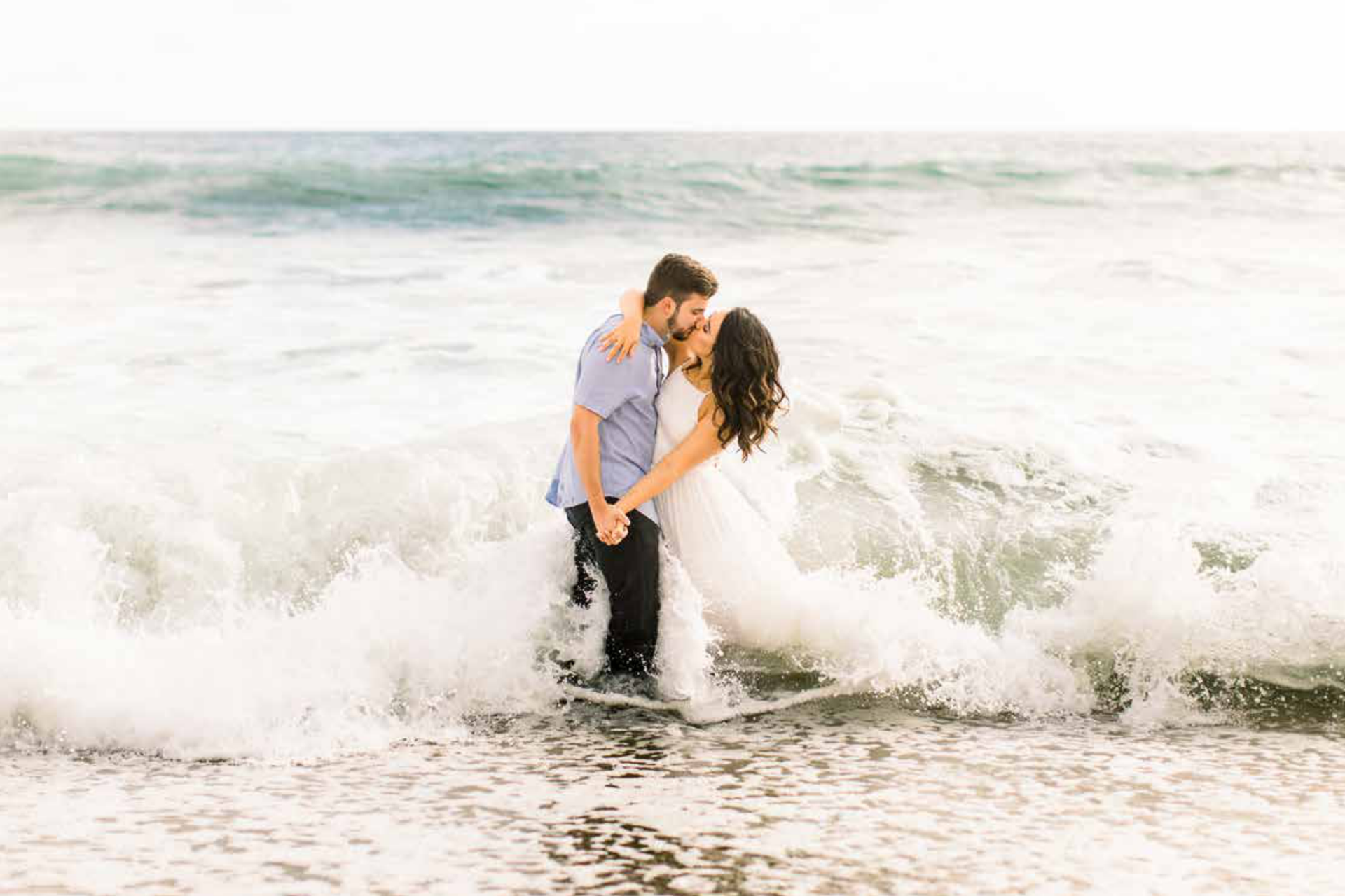 Engaged couple with a rock background by Shy Heart Studios