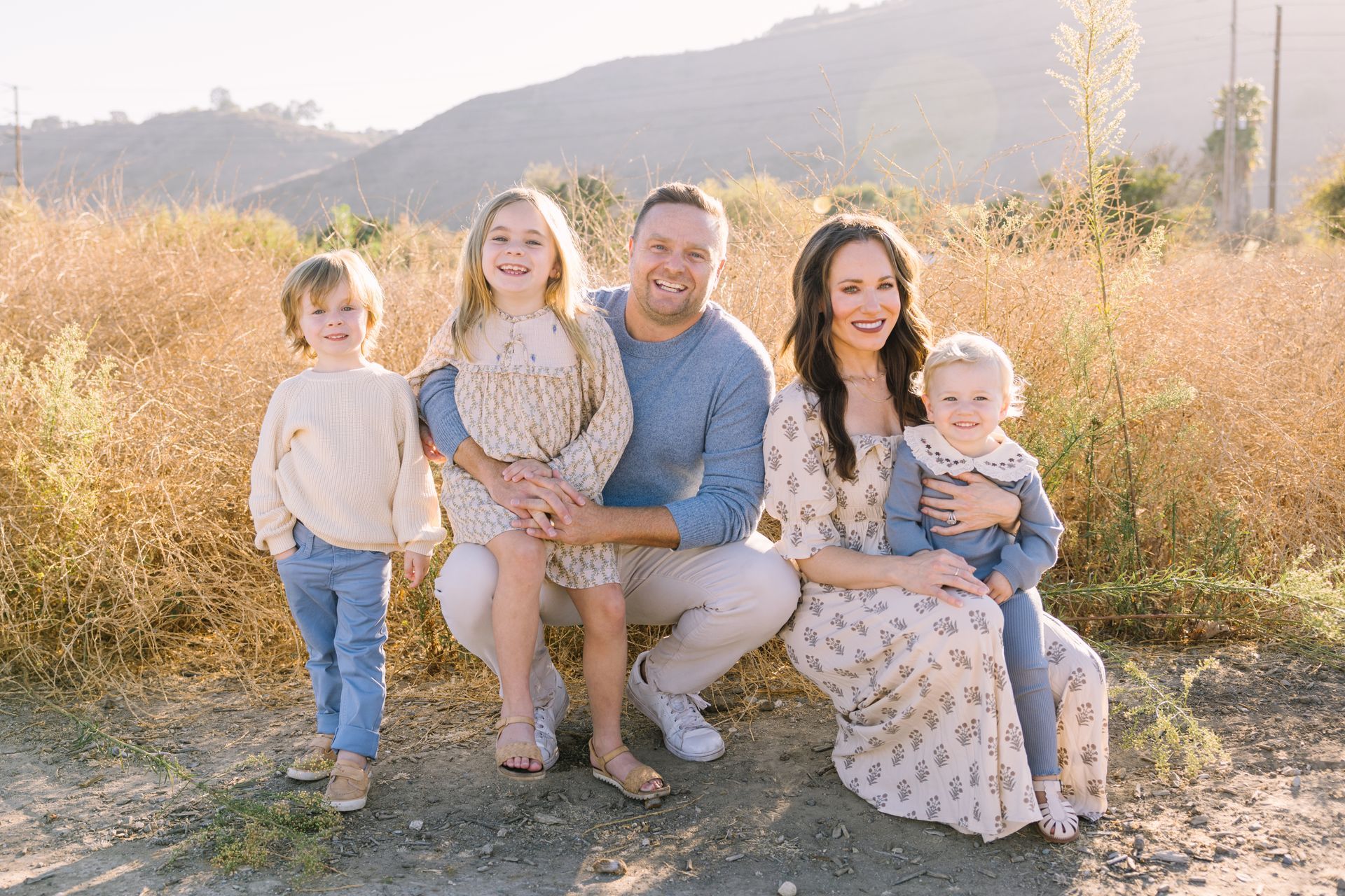 A small family sitting together on a bench captured by shy heart studios photographers