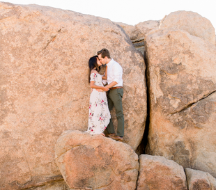 Engaged couple with a rock background by Shy Heart Studios