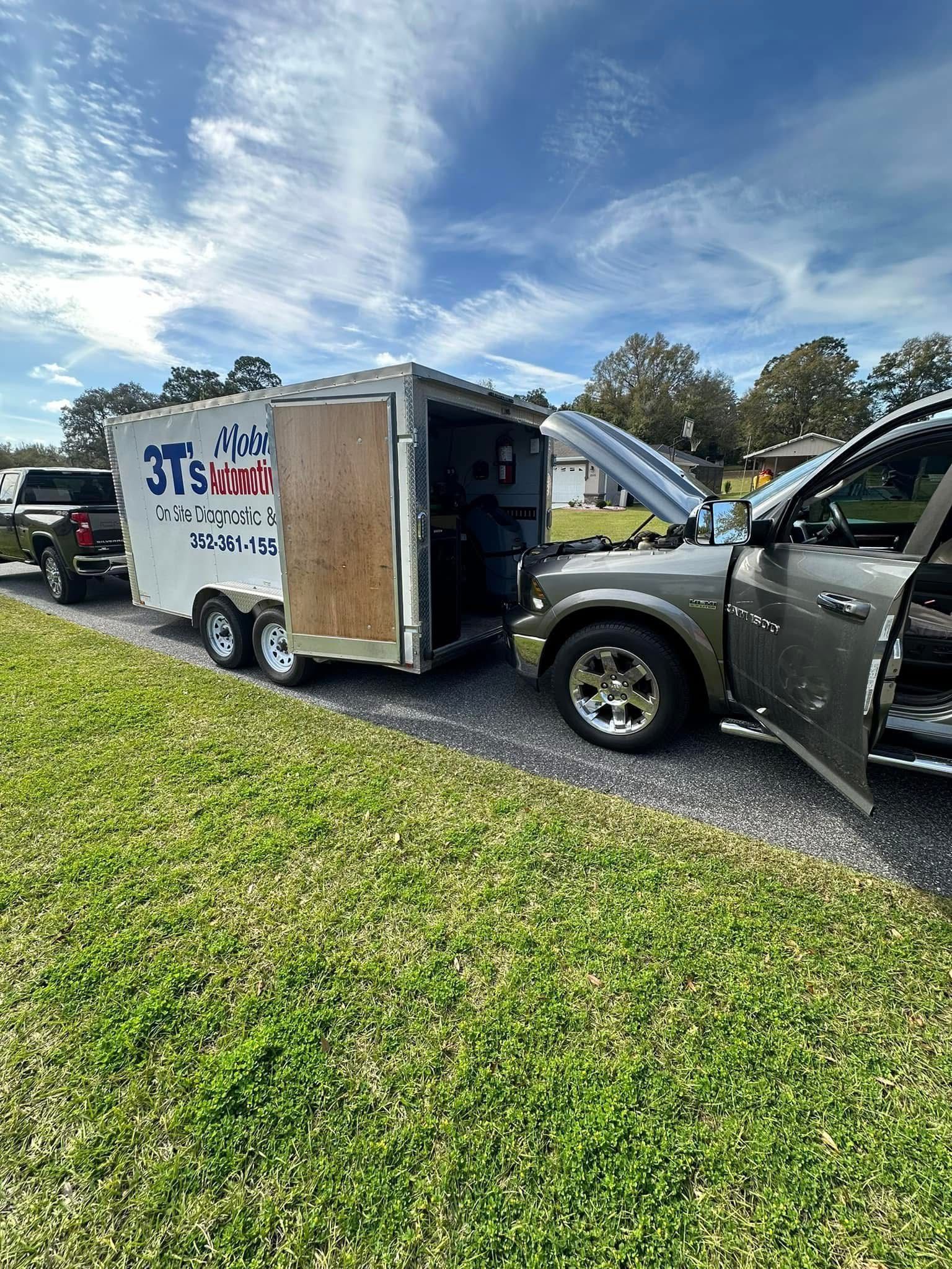 Truck parked next to trailer with open door on sunny day | 3T’s Mobile Automotive Repair Inc.