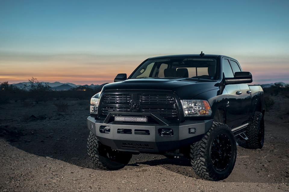 Black pickup truck with black front bumper and sunset in backdrop