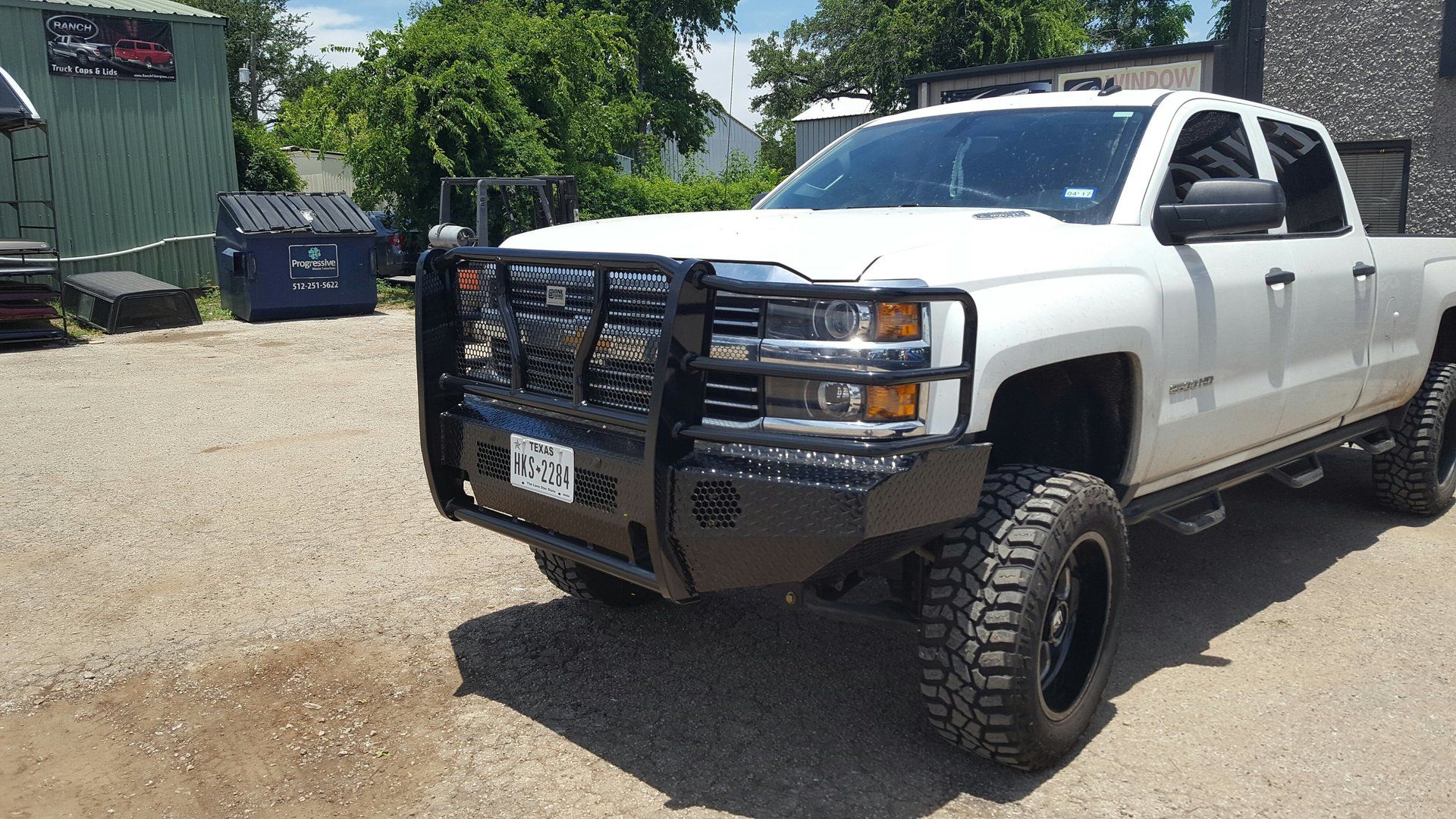 white pickup truck with black grill guard and front bumper