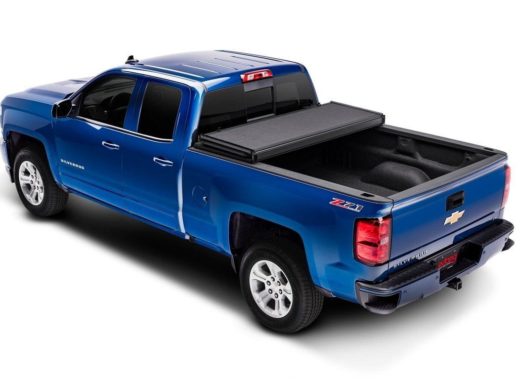 Candy Apple Blue Chevy four door pickup truck with folded up bed cover