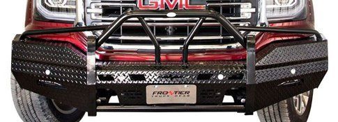 detail of black bumper and grill guard on  red GMC pickup truck