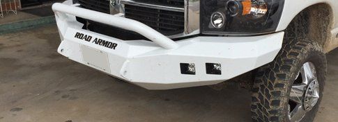 detail of white Road Armor bumper on white pickup truck