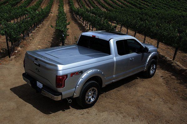silver ford pickup truck with matching truck bed cover that is closed