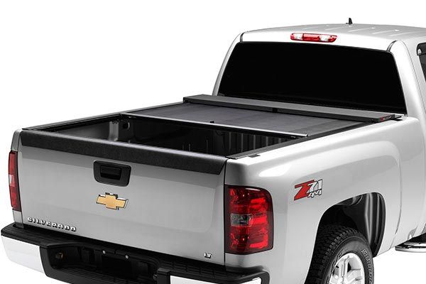 silver Chevy pickup truck with half-open rertractable truck bed cover