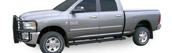 side view of silver Dodge Ram four door pickup with full running board