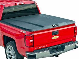 red Chevy Silverado with black truck bed cover that is closed