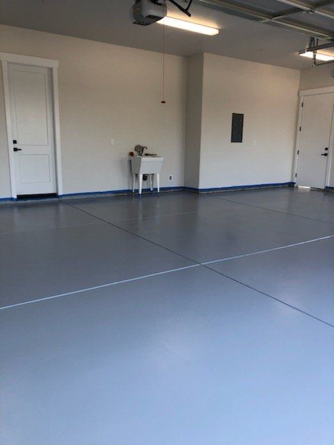 Finished Car Garage in Residential Home with freshly painted walls and epoxy floor